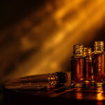 Cluster of amber glass botanical extract vials with overlapping beams of light blending together