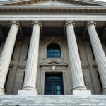 Federal government building facade with tall columns photographed from below in daylight